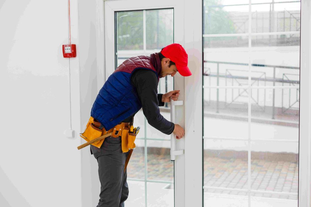 bearded adult repairman fixing window compressed
