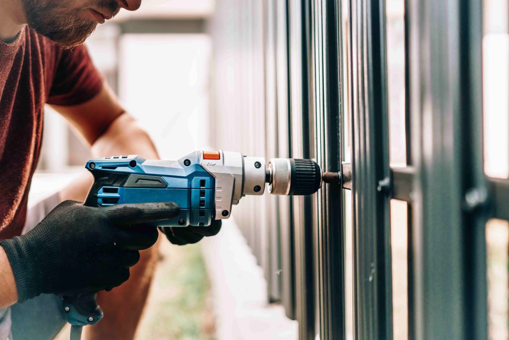 man working with electric screwdriver construction site compressed (1)