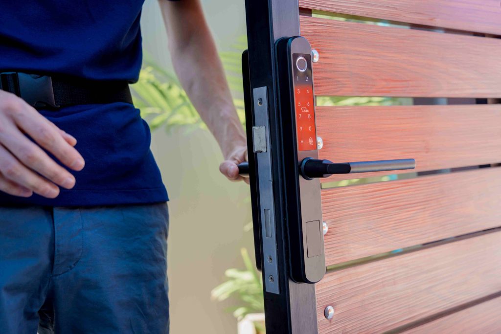 technician installs modern smart door lock wood door compressed